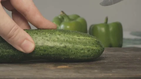 Close up of green fresh cucumber cut in slices with knife Stock Footage 134069320
