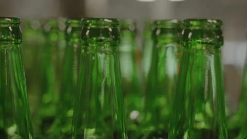 Close-up of green glass bottles moving along the production line Stock Footage 189275553