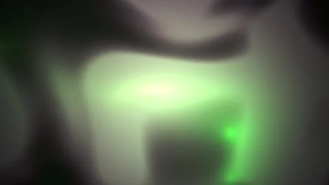 Close-up of a green laser beam shining through a dark object. Stock Footage 335946532