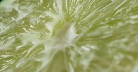 Close-up of the green lime incision through which a drop of water flows Stock Footage 152093300