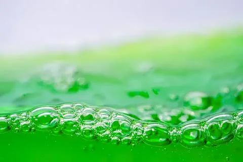 Close-up of green liquid with bubbles and foam Stock Photos