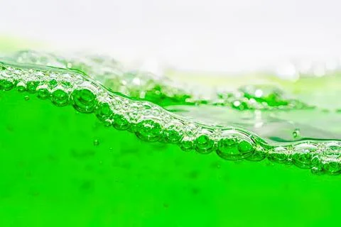 Close-up of green liquid with bubbles and foam Stock Photos