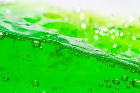 Close-up of green liquid with bubbles and ripples Stock Photos