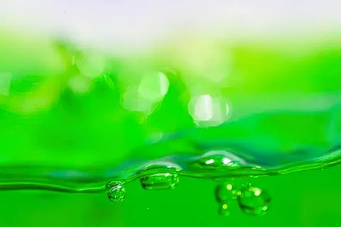 Close-up of green liquid with bubbles and ripples Stock Photos