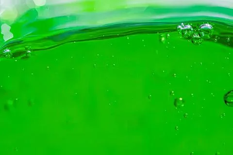 Close-up of green liquid with bubbles and ripples Stock Photos