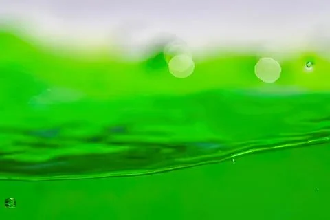 Close-up of green liquid with bubbles and ripples Stock Photos