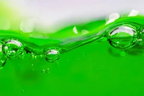 Close-up of green liquid with bubbles and splash Stockfoto's