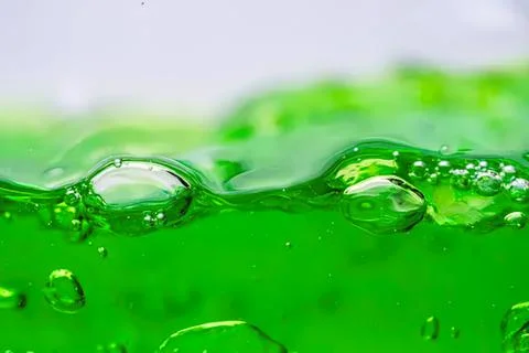 Close-up of green liquid with bubbles and splash Stock Photos