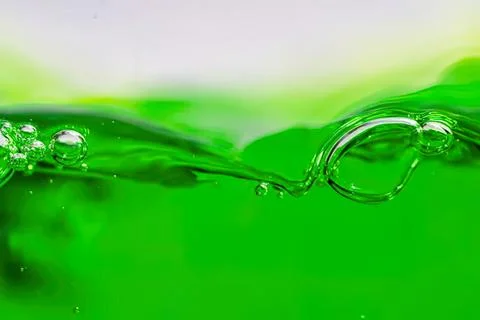 Close-up of green liquid with bubbles and waves Stock Photos