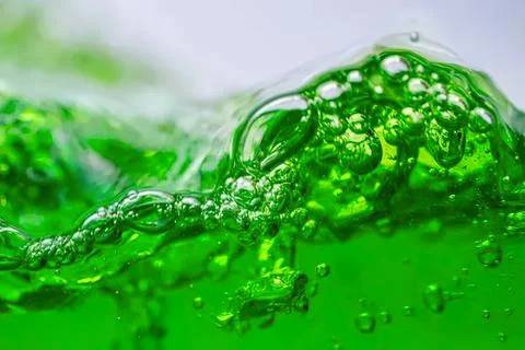 Close-up of green liquid with bubbles in motion Stock Photos