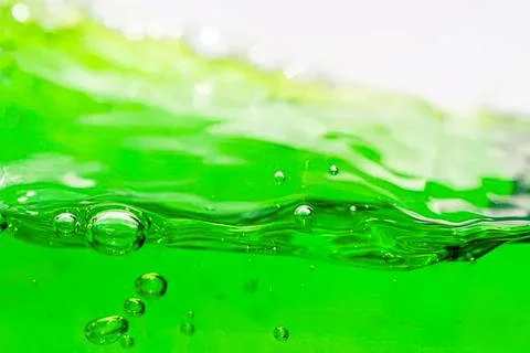 Close-up of green liquid with bubbles in motion Stock Photos
