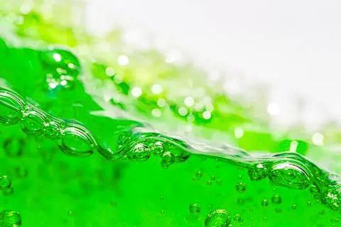Close-up of green liquid with bubbles in motion Stock Photos