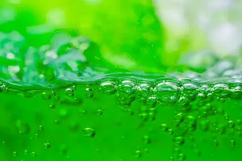 Close-up of green liquid with bubbles in motion Stock Photos