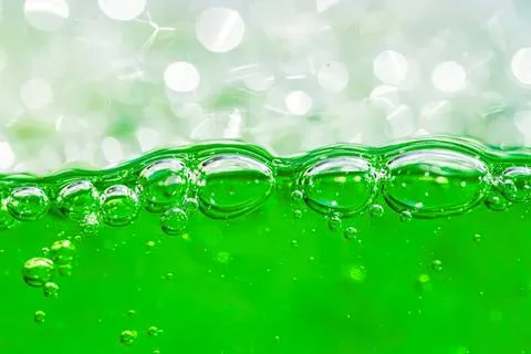 Close-up of green liquid with bubbles in water Stock Photos