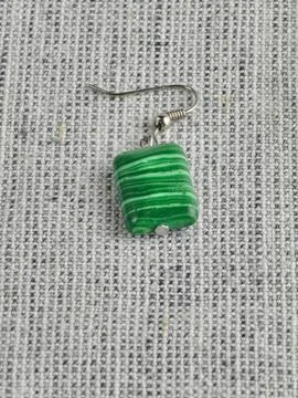 Close-up of green malachite rectangular bead earring against a burlap backgro Stock Photos