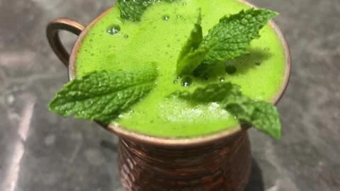 Close Up of Green Mocktail with Mint Leaves in Copper Cup Stock Footage 333152767