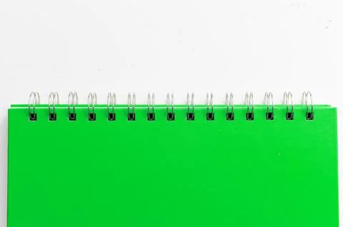 Close-up of a green notebook with checkered pages. Spiral notebook isolated Stock Photos