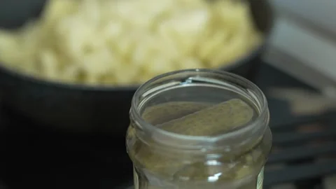 Close-up of green pickled cucumbers in a clear glass jar Stock Footage 333580529