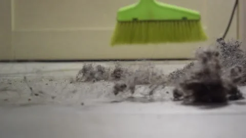 Close up of green plastic broom sweeping floor in house Stock Footage 274242624