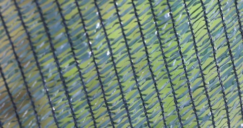 Close up of green plastic safety net swaying in the wind Stock Footage 336748866