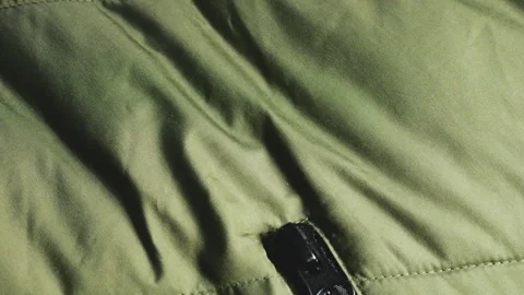 Close-up of a green quilted jacket fabric.  Stock Footage 346189443