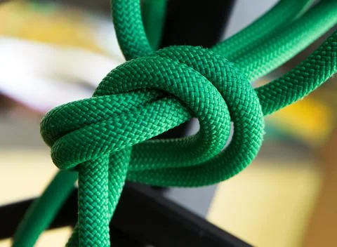 Close up green rope with knot on selective focus background Stock Photos