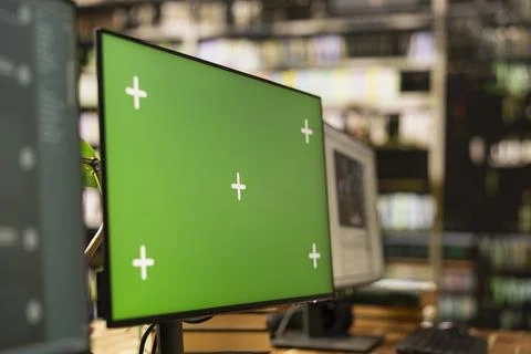 Close up of green screen chroma key on desktop monitor in library Stock Photos