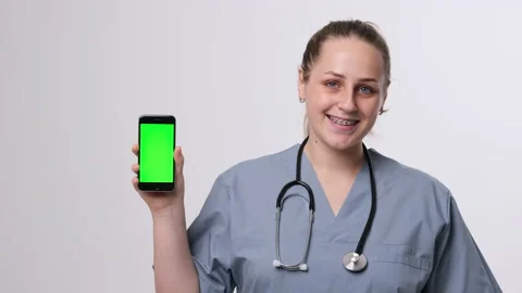 Close up of green screen on phone held by doctor Stock Footage 166097292