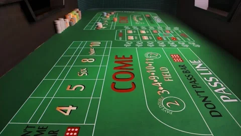 Close up of green table for playing craps in a casino. The red dice fall onto Stock Footage 155308548