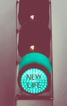 Close up on green traffic light message NEW LIFE Stock Photos