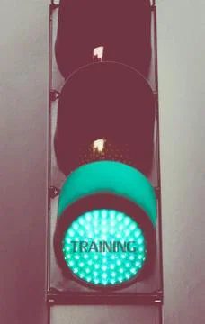 Close up on green traffic light message TRAINING Stock Photos