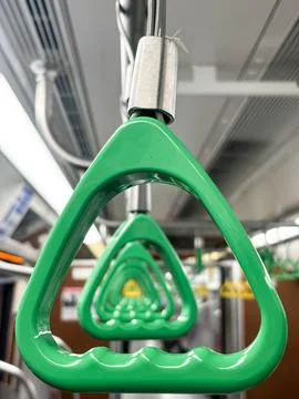 Close Up of Green Triangle Handstraps Inside Commuter Train Stock Photos