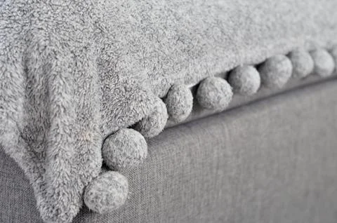 Close up grey blanket with pompoms Foto stock