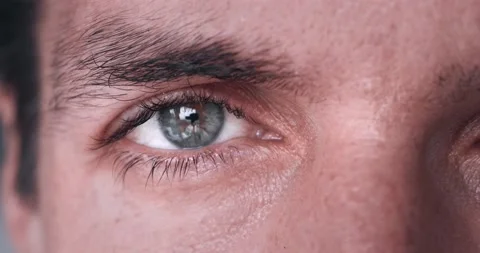 Close-up of the grey eye of a millennial man in his 30s. Close up man's eye Stock Footage 232022432