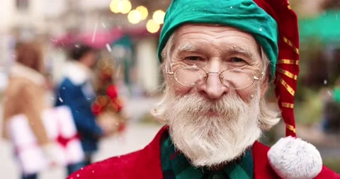 Close up of grey-haired Santa Clause in glasses looking at camera and kindly Stock Footage 142240918