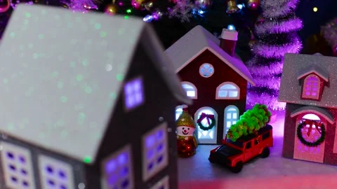 A close-up of a grey house spinning in front of a Christmas town Stock Footage 319896414