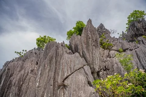 Close up on the grey limestone cliffs against the blue sky in Coron, Palawa.. Stock Photos