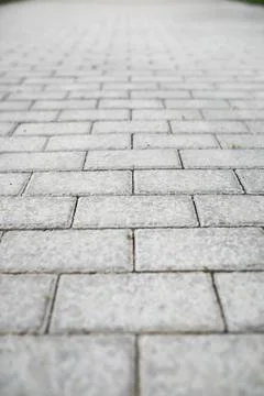 Close-Up of Grey Paving Stone Pattern with Shallow Depth of Field on Walkway Stock Photos
