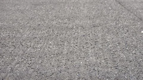 Close up of grey rough asphalt surface texture with small pebbles and stone.. 스톡 사진