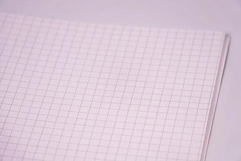 Close-up grid notebook page, simple white background, emphasizing clean works Stock Photos