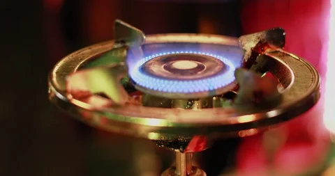Close-up of a griddle with oranges put on a round gas burner. Stock Footage 103383832