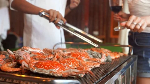 Close-up grill crab prawn and shell on flaming Charcoal stove. Group of tourist  Stock Footage 111267417