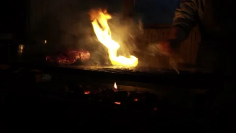 Close-up of a grill exploding in fire from filling it with oil next to a cooking 動画素材 164623155