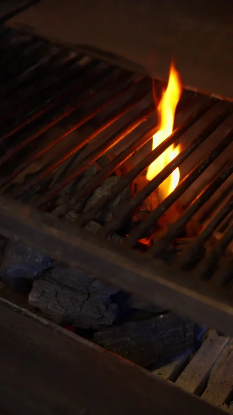 Close up grill grate with rising flame and hot charcoal barbecue fire Vídeo Stock 331352233