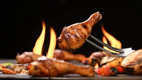 Close up grill roast bbq chicken leg on the flaming grill . HD slow motion . Видео 125411536