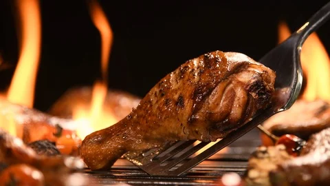 Close up grill roast bbq chicken leg on the flaming grill , 4k Video stock 125411715