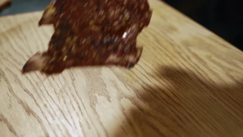Close up of grilled beef ribs being put to the wooden cutting board in expensive Stock Footage 91192750