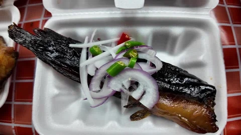 Close-Up of Grilled Catfish with Fresh Onion and Chili Stock Footage 339650257