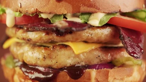 Close-up of a grilled chicken burger rotation on a brown background. Stock Footage