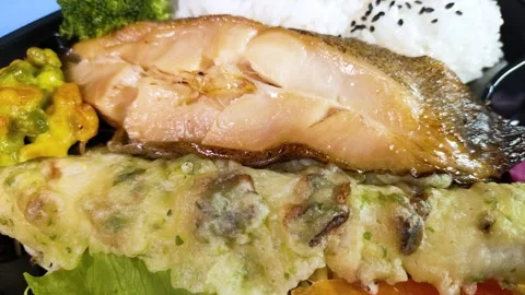 Close-up of a grilled fish bento box  rotating Stock Footage 327570255